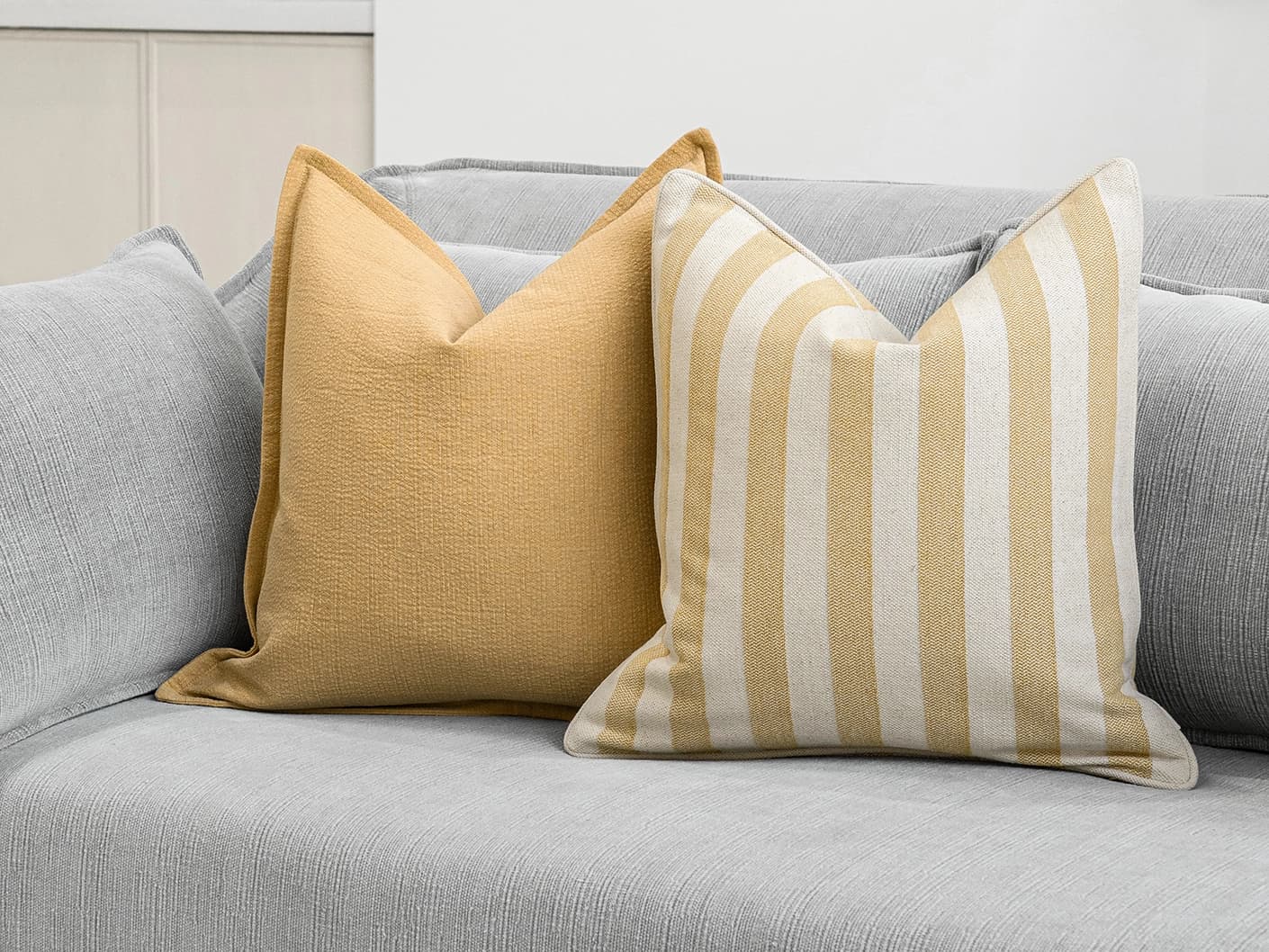 Ansh Bundle bundle cushions in yellow and white, shown in a lifestyle front view