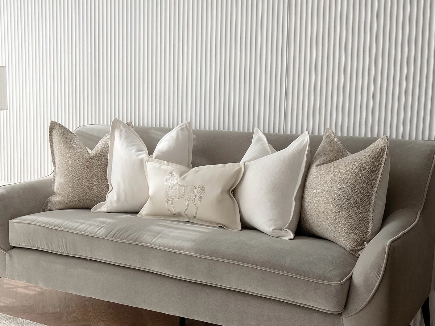Antonio Bundle bundle cushions in white and beige, shown in a lifestyle front view