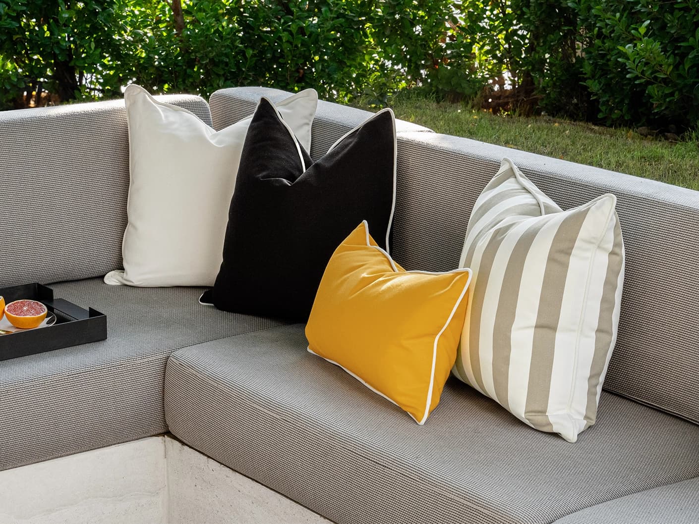 Apollo Bundle bundle cushions in yellow, ivory, beige and black, shown in a lifestyle front view