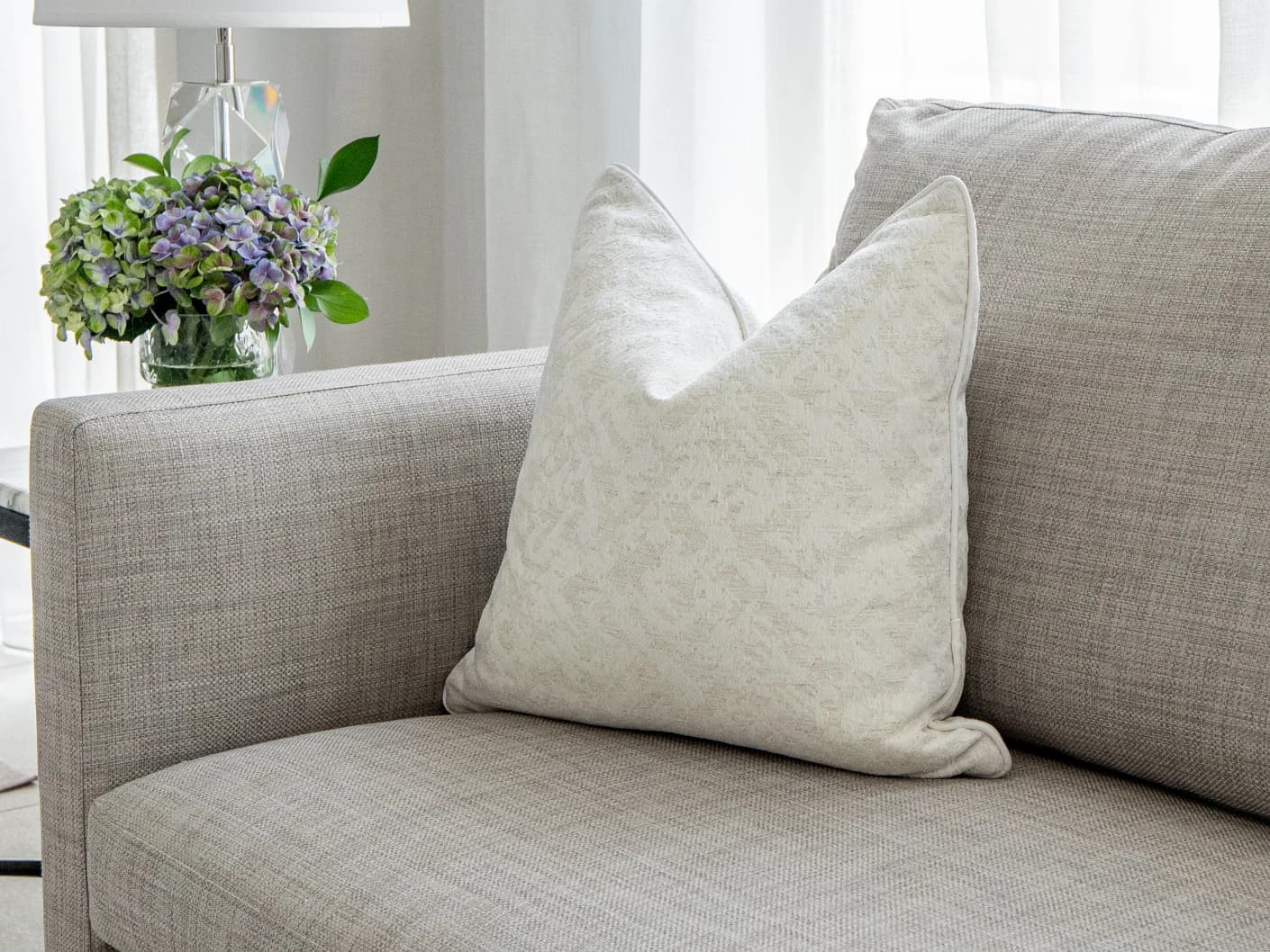 Arcie Bianca single cushions in white, shown in a lifestyle front view