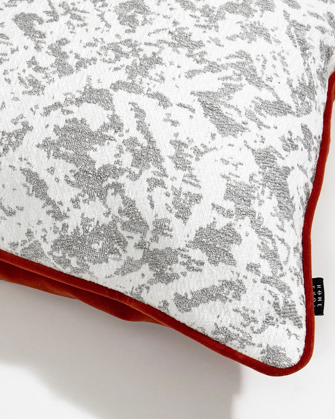 Arcie Tangelo cushion in white, grey and orange, shown in a product close-up top view as image 2