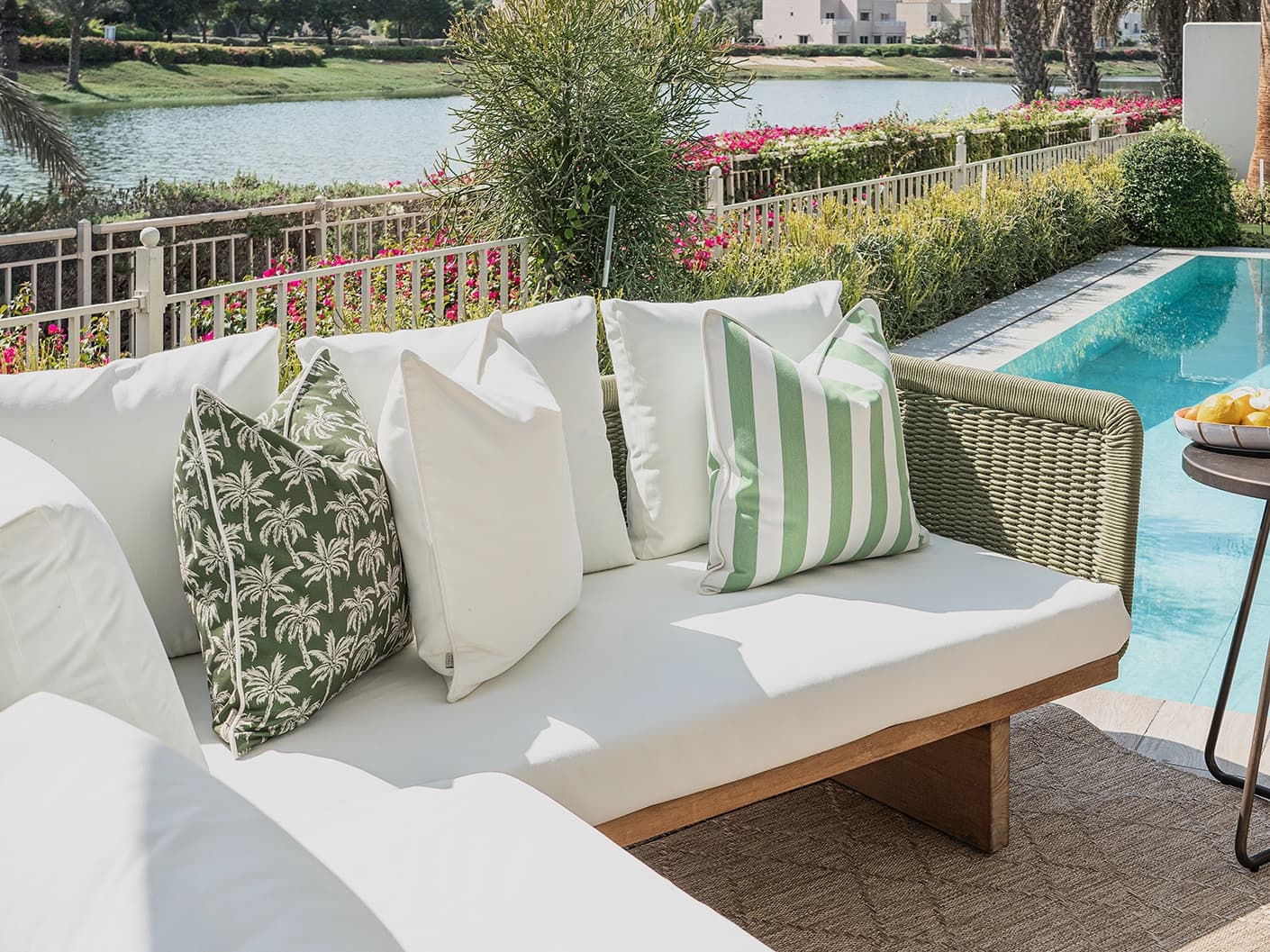 Arina Bundle bundle cushions in green and ivory, shown in a lifestyle front view