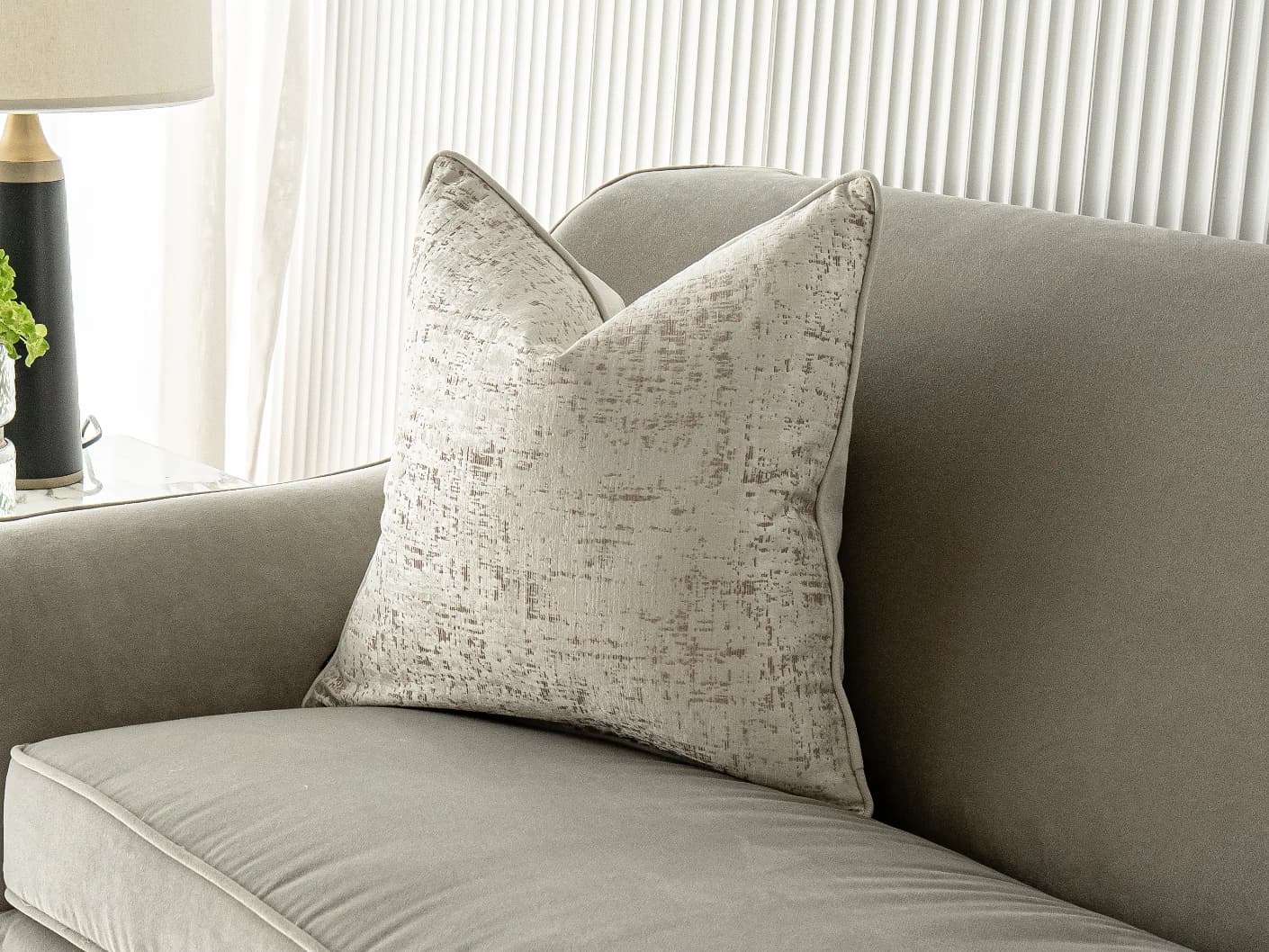 Arlo Bianca single cushions in white, shown in a lifestyle front view