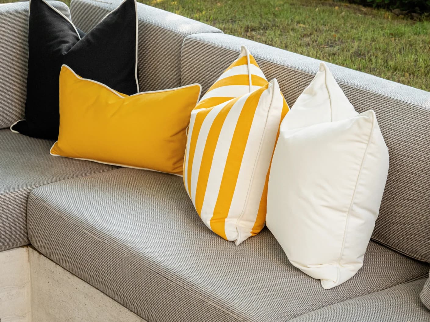 Arun Bundle bundle cushions in yellow, ivory and black, shown in a lifestyle front view