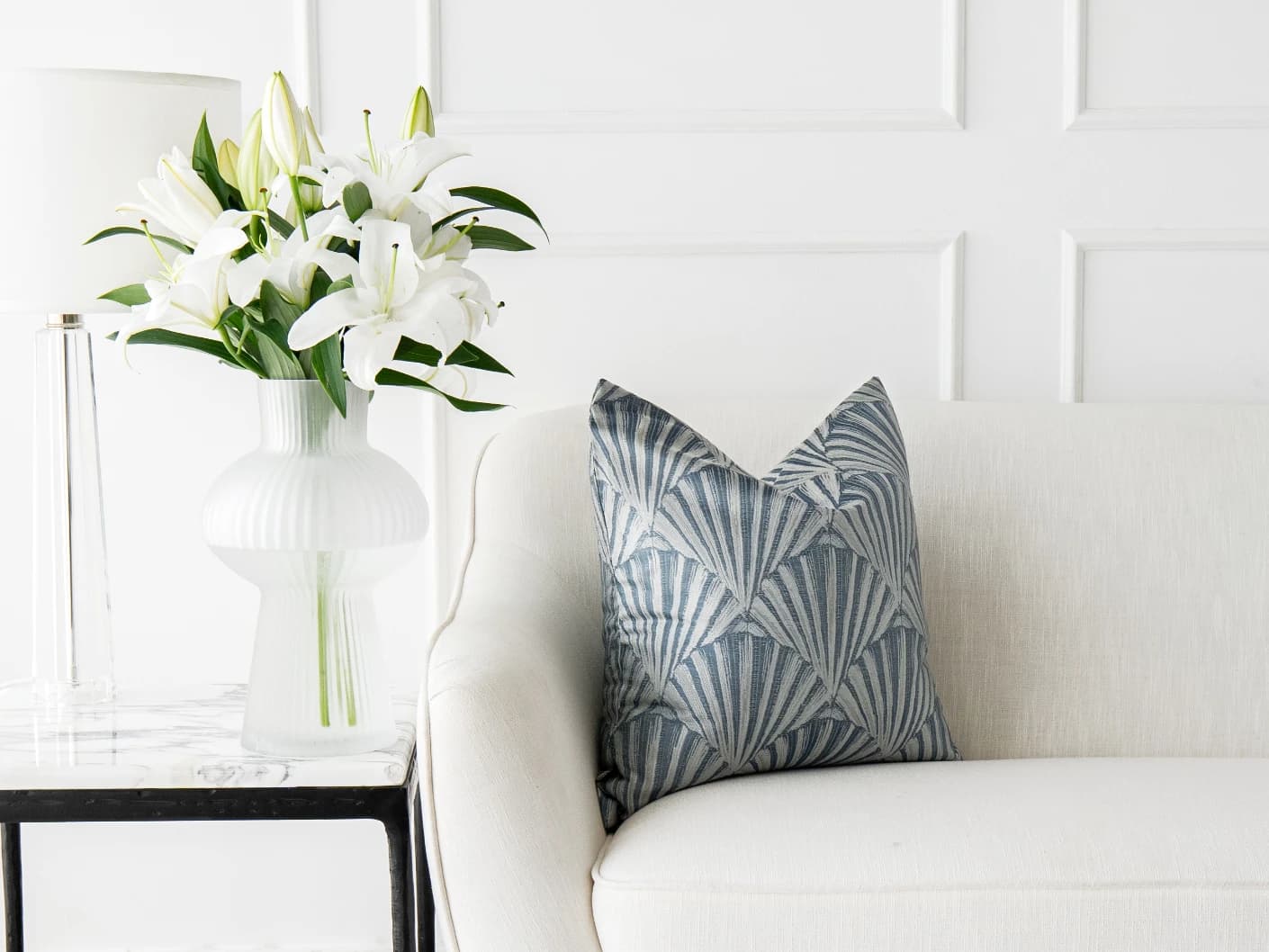 Ashlyn Canova single cushions in blue and silver, shown in a lifestyle front view