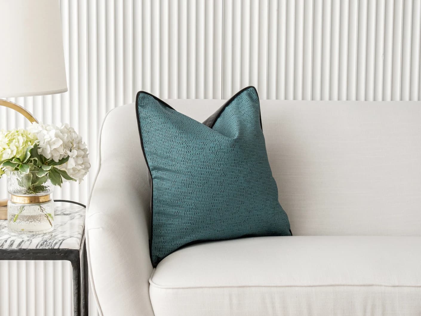 Asta Canova single cushions in blue, shown in a lifestyle front view