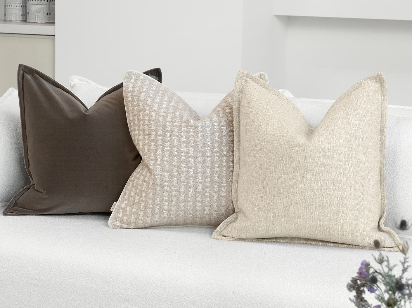 Astle Bundle bundle cushions in ivory, beige and brown, shown in a lifestyle left view