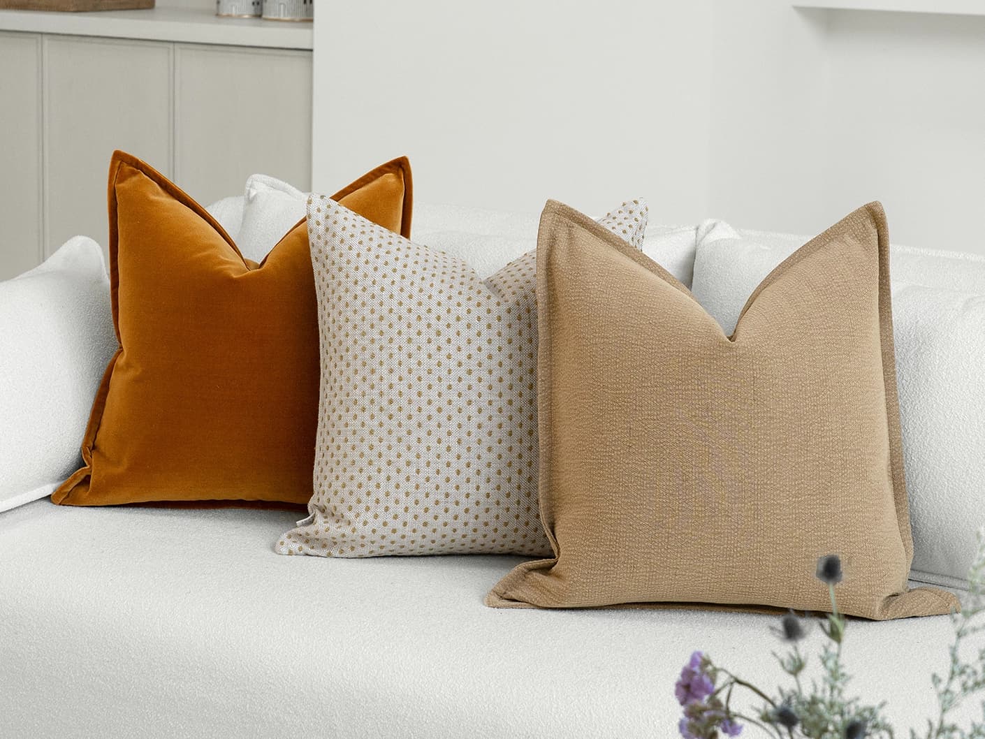 Astra Bundle bundle cushions in beige, brown and orange, shown in a lifestyle front view