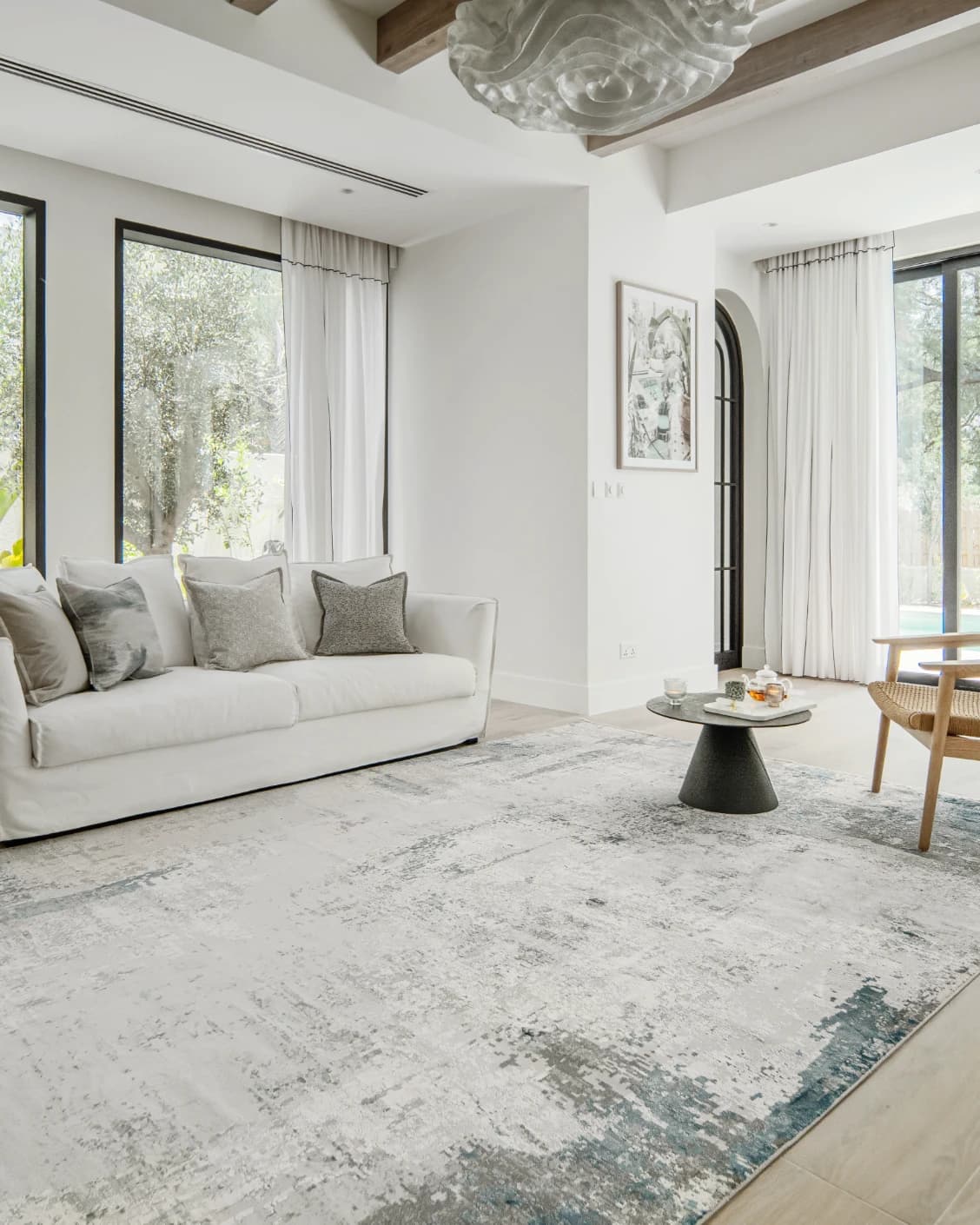 Athena Sky carpet in sky, blue and grey, shown in a lifestyle left view as image 8