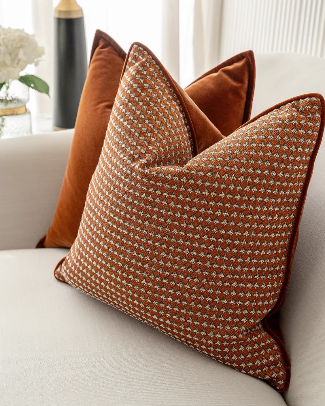 Auburn Bundle cushion in rust, white and orange, shown in a lifestyle front view as image 7