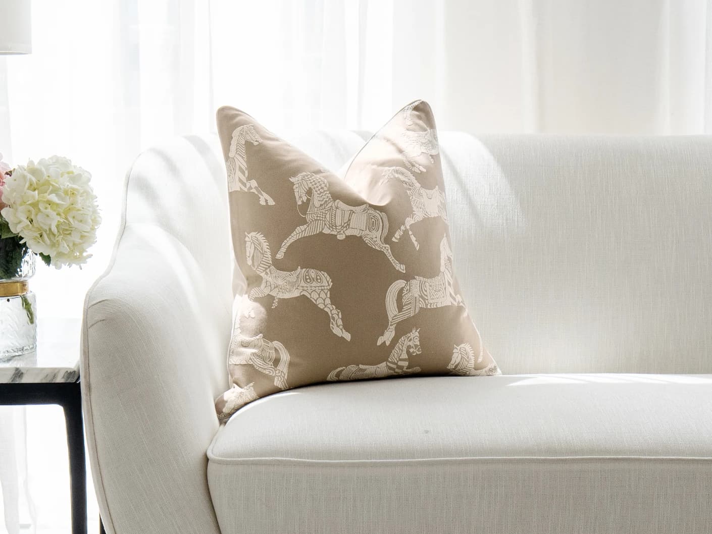 Aurora Hodler single cushions in beige, shown in a lifestyle front view
