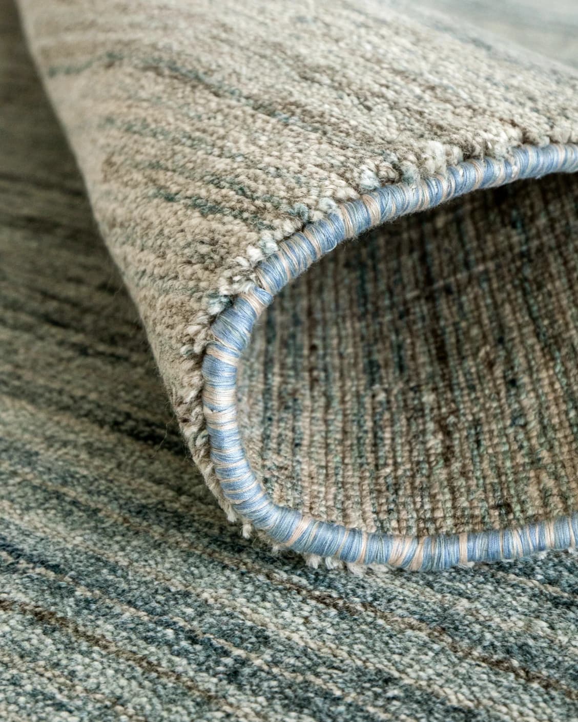 Ava Sandy carpet in sandy, turquoise and beige, shown in a product close-up as image 6