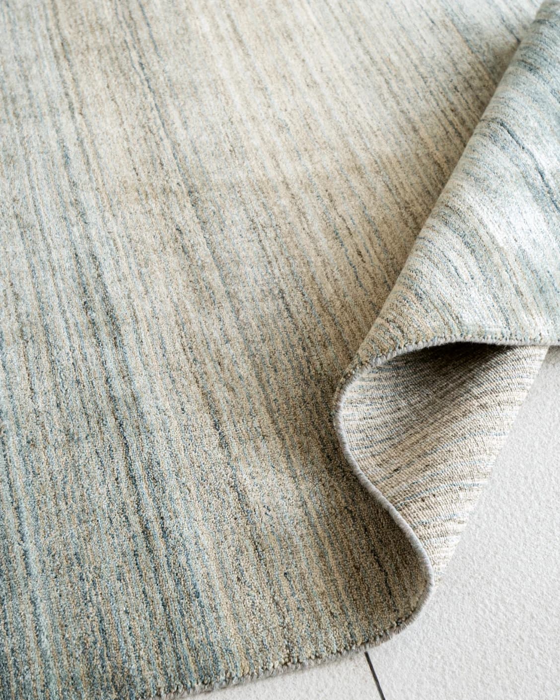 Ava Sandy carpet in sandy, turquoise and beige, shown in a product close-up top view as image 8