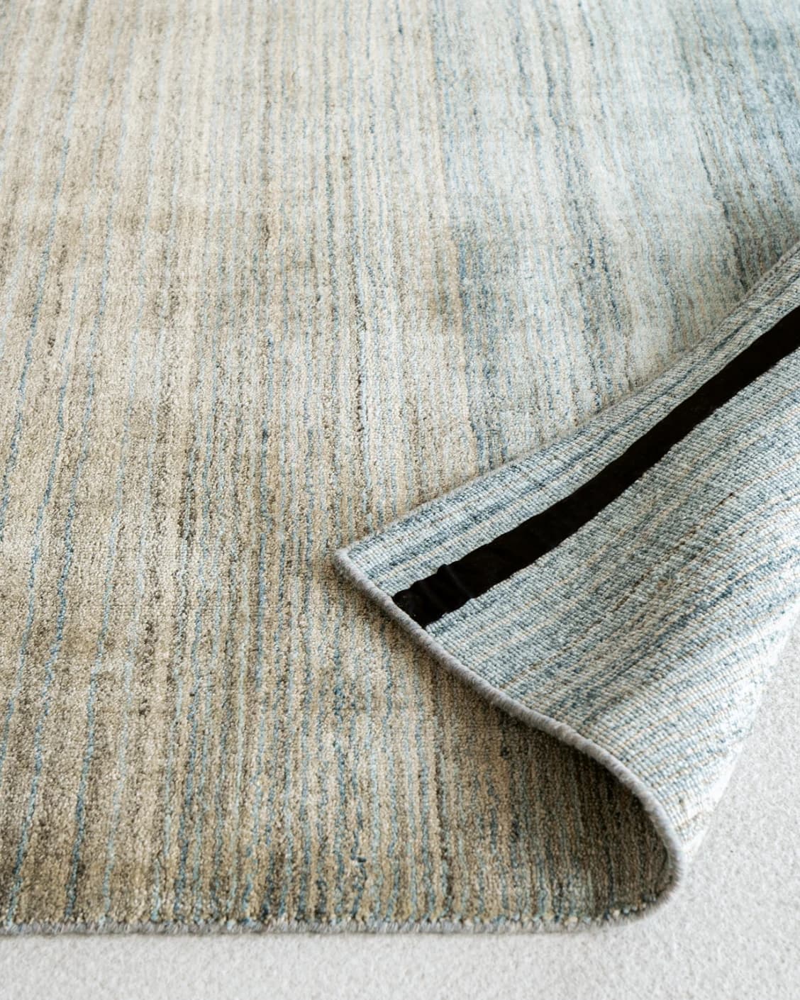 Ava Sandy carpet in sandy, turquoise and beige, shown in a product front view