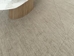 Axis Oat carpet in beige and brown, shown in a lifestyle close-up front view