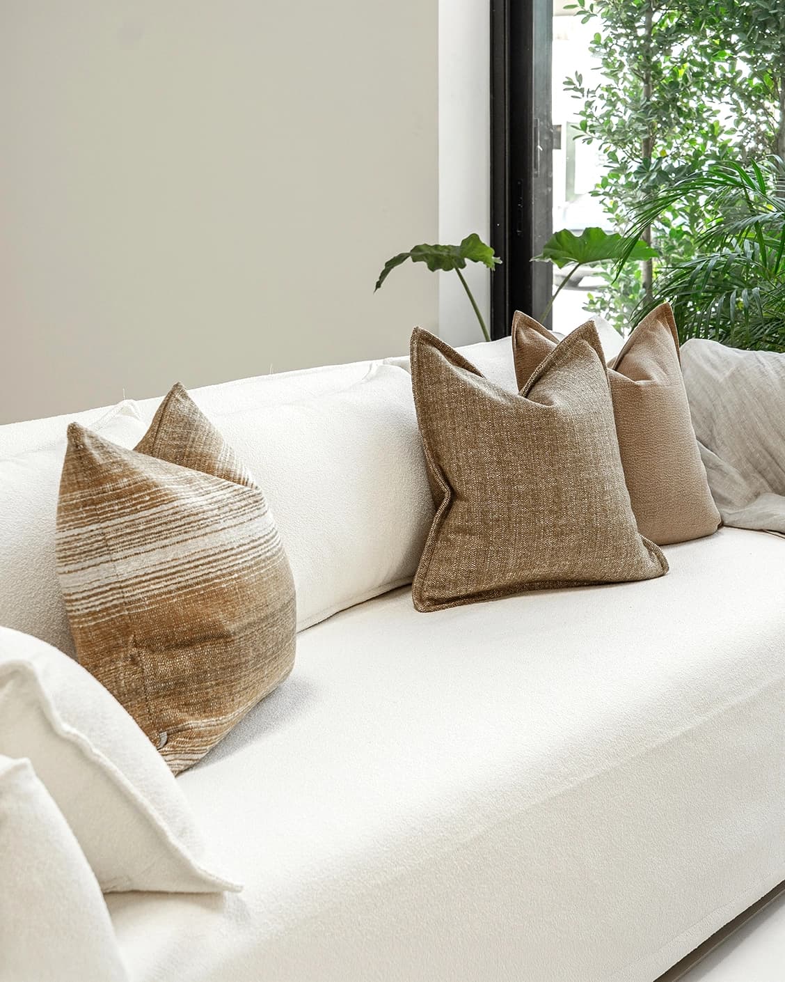 Aya Bundle cushion in brown, shown in a lifestyle left view as image 2