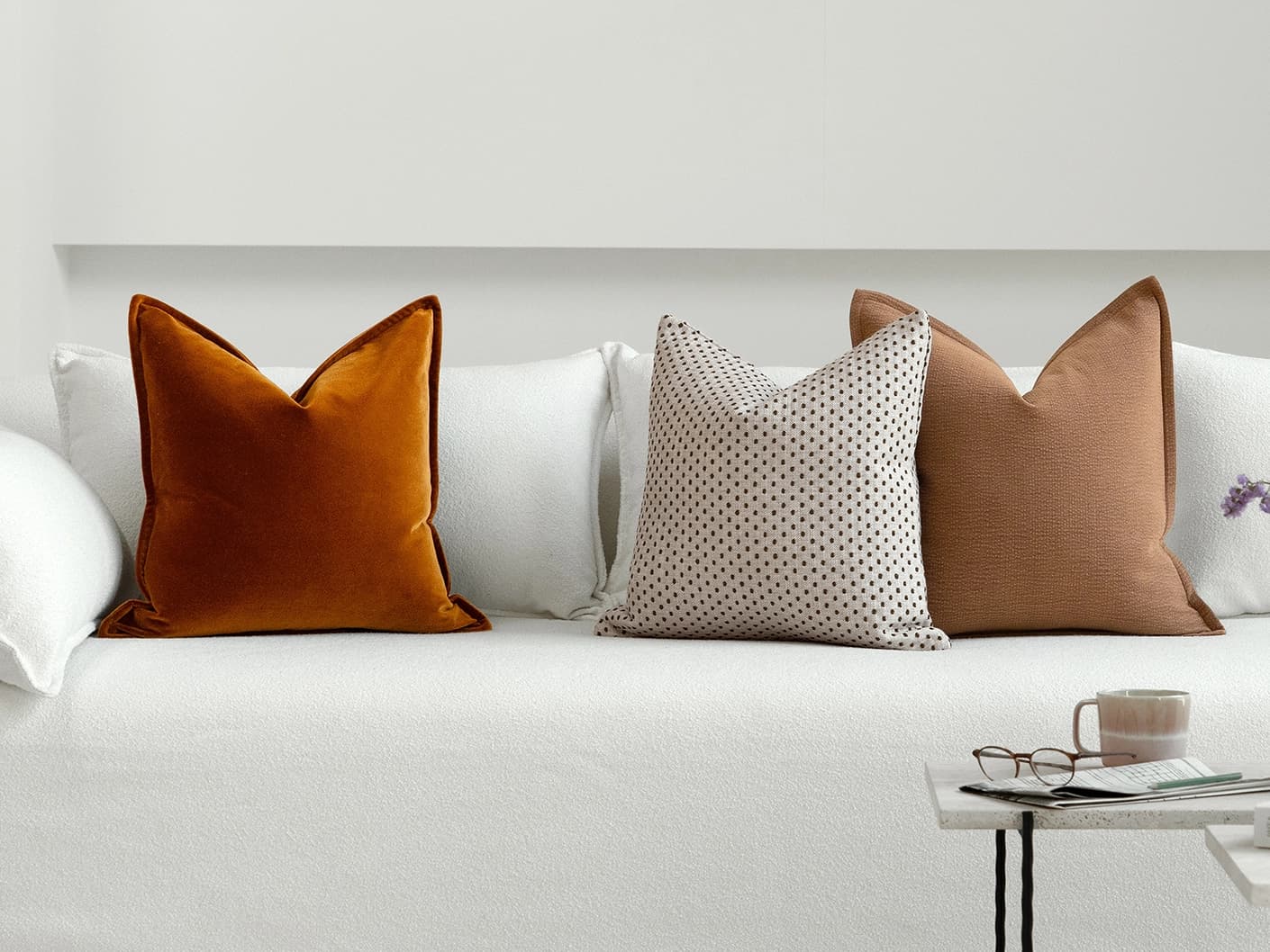 Azar Bundle bundle cushions in beige and rust, shown in a lifestyle front view