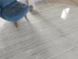 Beatrice Alba Round carpet in grey, shown in a lifestyle front view