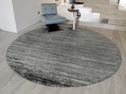 Beatrice Ashton Round carpet in grey, shown in a lifestyle front view