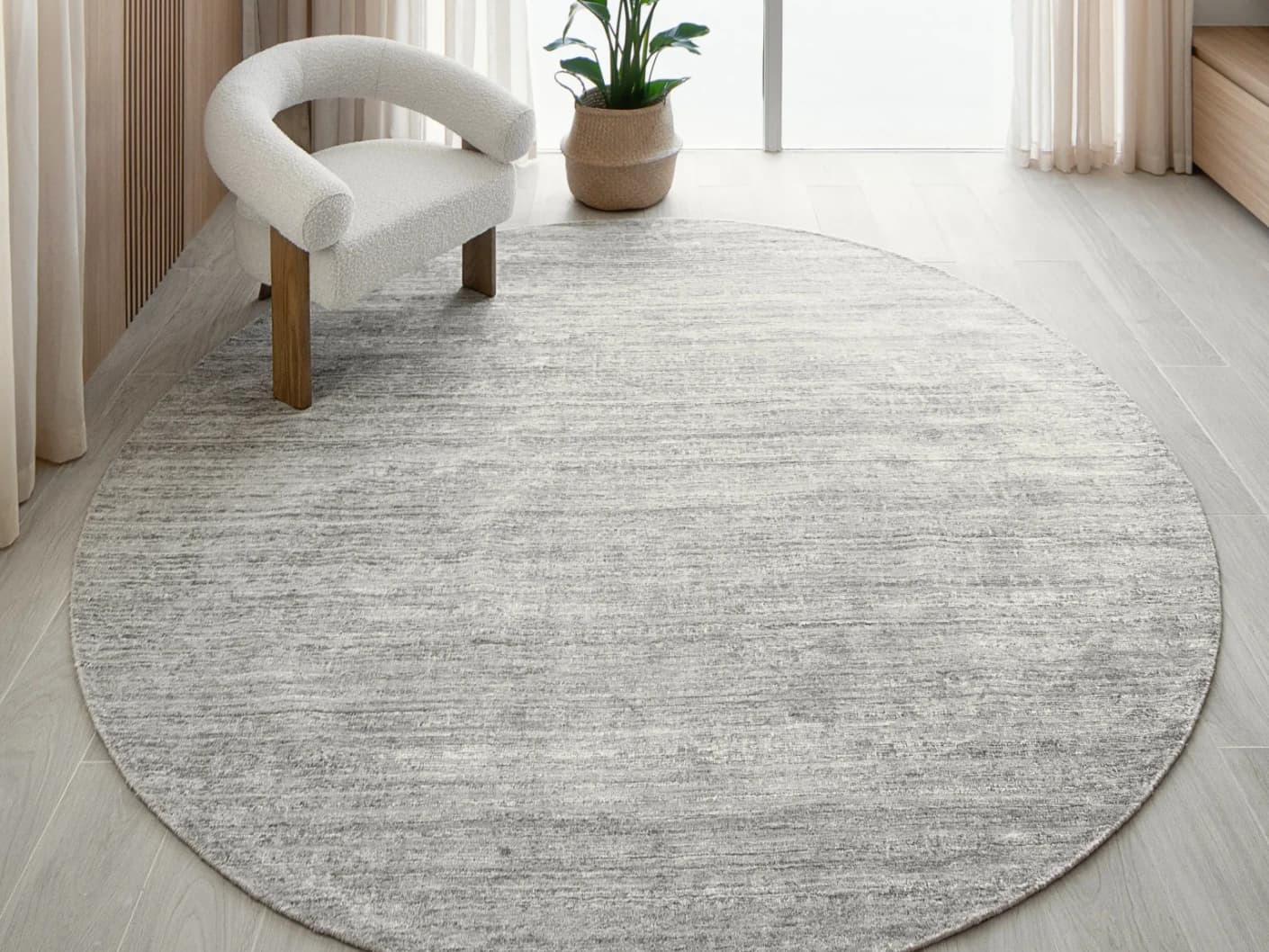 Beatrice Dune 02 Round carpet in grey, shown in a lifestyle front view