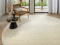 Beatrice Sandy 02 Round carpet in beige, shown in a lifestyle front view