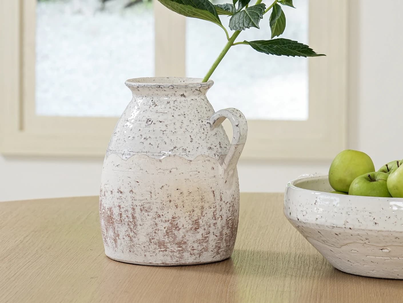 Becca Terra vases in soft stone and white, shown in a lifestyle front view