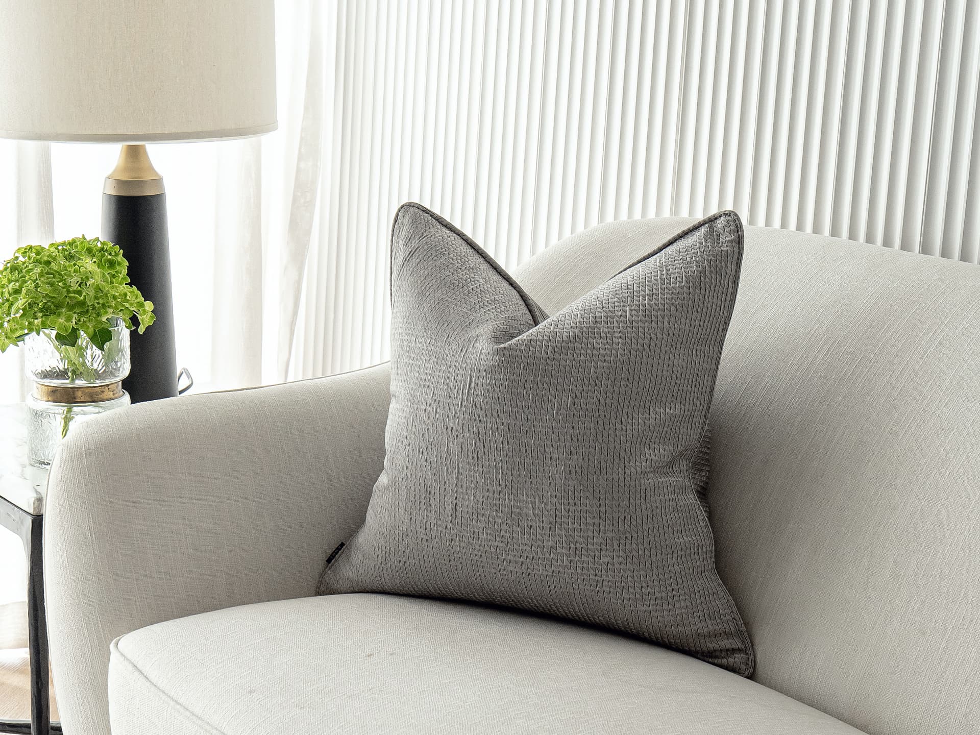 Benjamin Laurent single cushions in silver and black, shown in a lifestyle right view