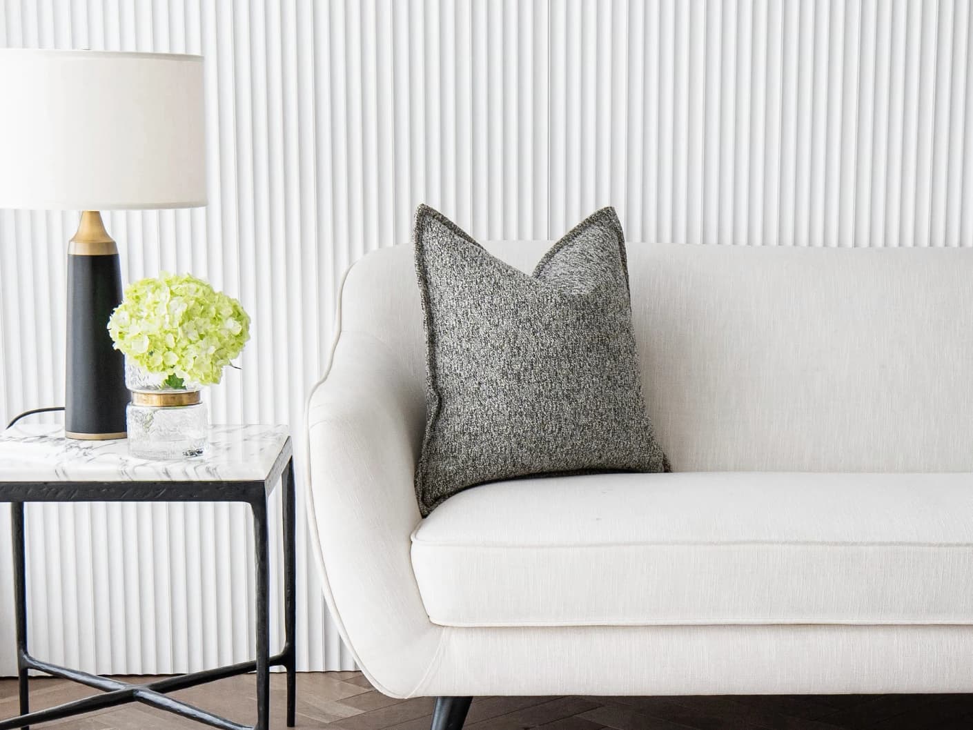Bennett Steele single cushions in silver and grey, shown in a lifestyle front view