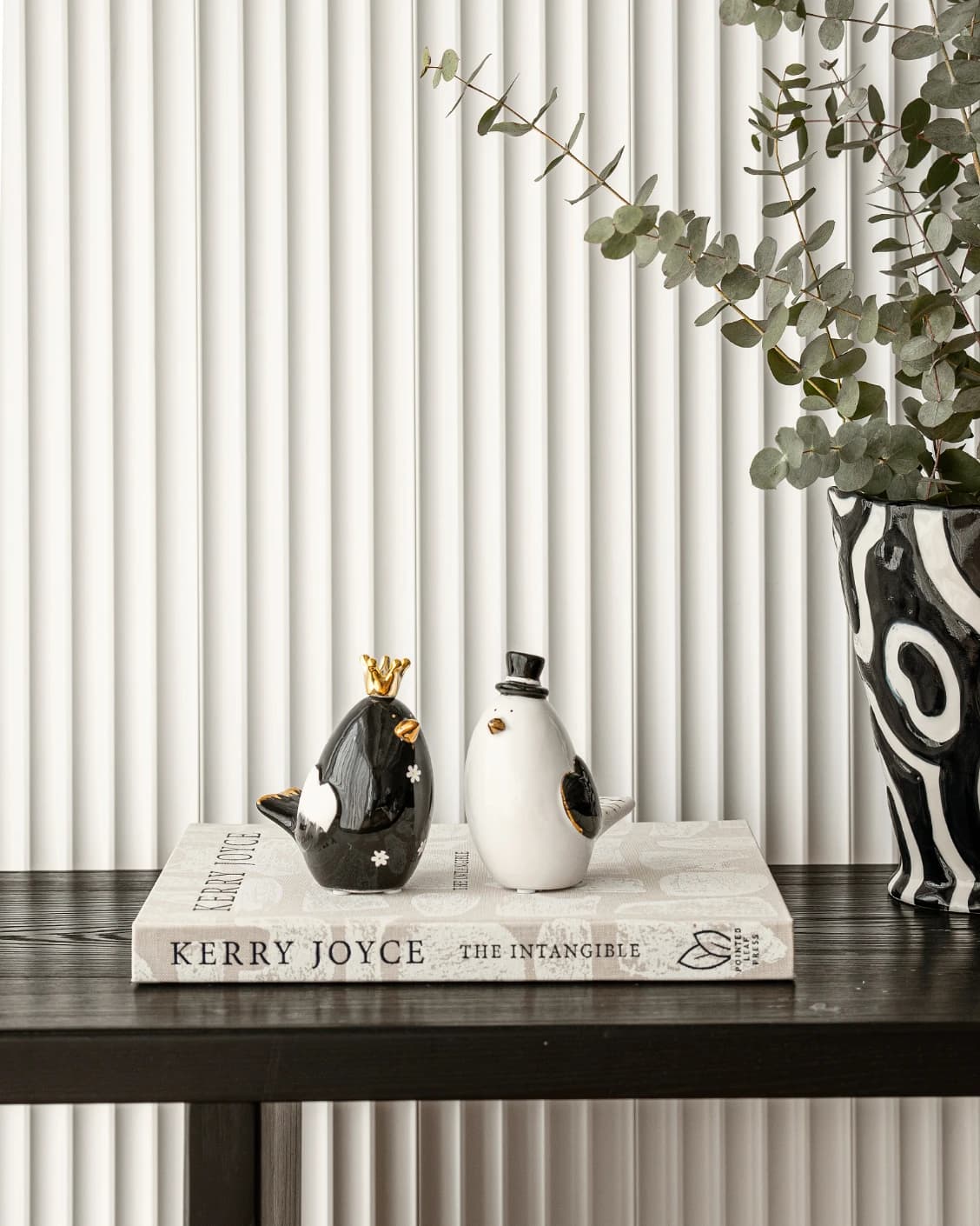 Berdy Arneson statues and sculptures in gold, white and black, shown in a lifestyle front view as image 4