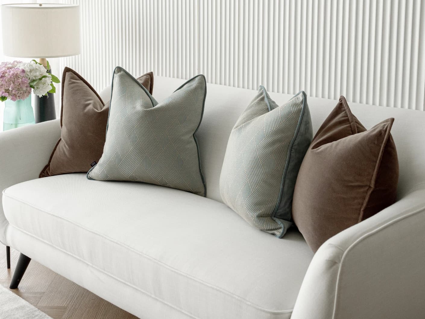 Bernie Bundle bundle cushions in brown and blue, shown in a lifestyle front view