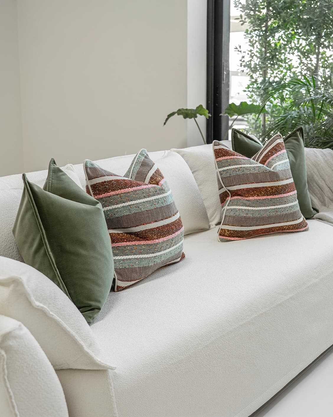 Blaire Bundle cushion in multicolour and green, shown in a lifestyle left view as image 2
