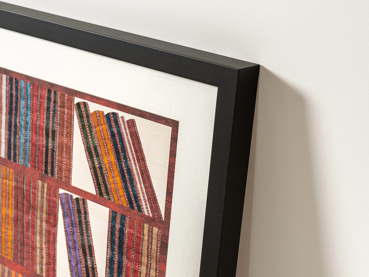 Books fine art print in rust, blue and multicolour, shown in a lifestyle left view as image 2