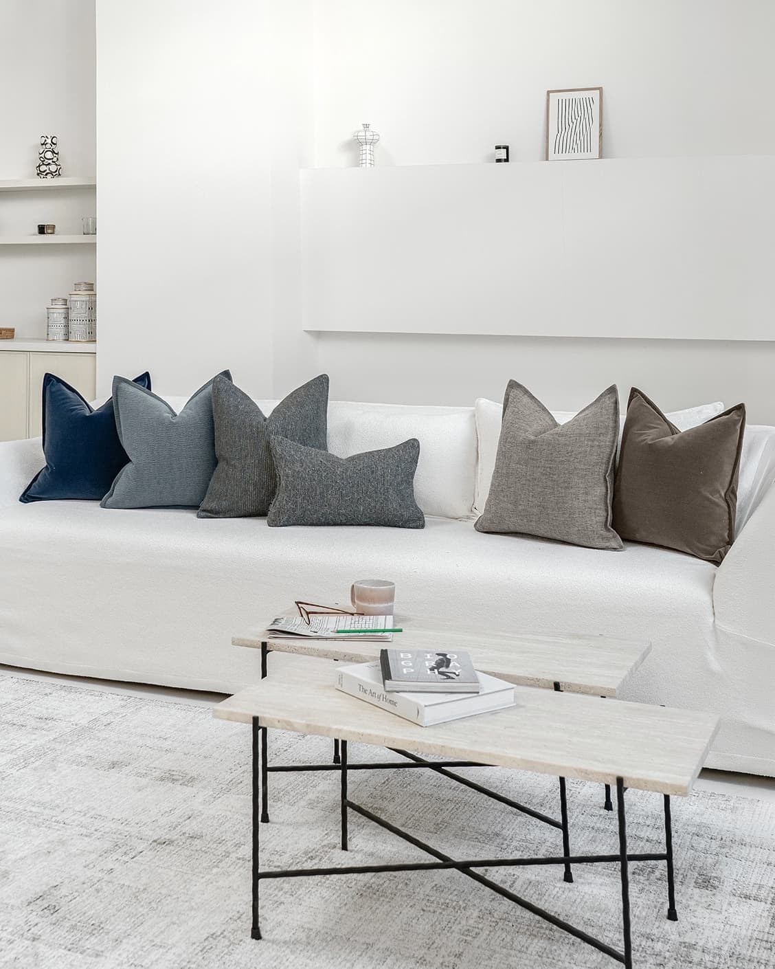 Bracia Bundle cushion in brown, grey and blue, shown in a lifestyle front view as image 2