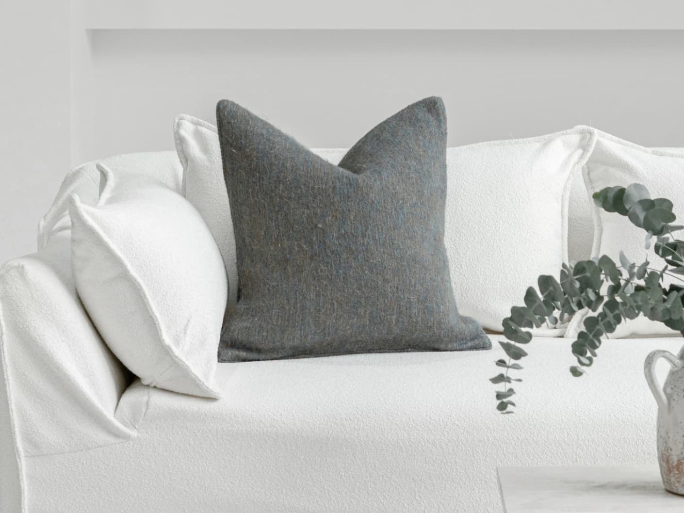 Bree Canova single cushions in blue and grey, shown in a lifestyle front view