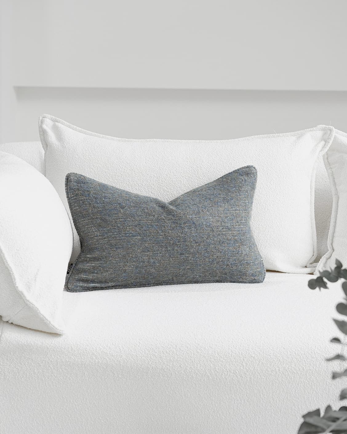Bree Canova II cushion in grey and blue, shown in a lifestyle front view as image 2