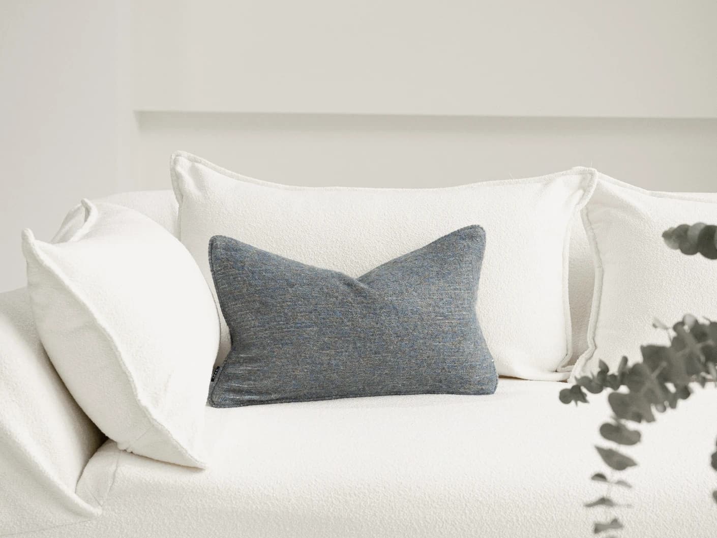 Bree Canova II single cushions in grey and blue, shown in a lifestyle front view
