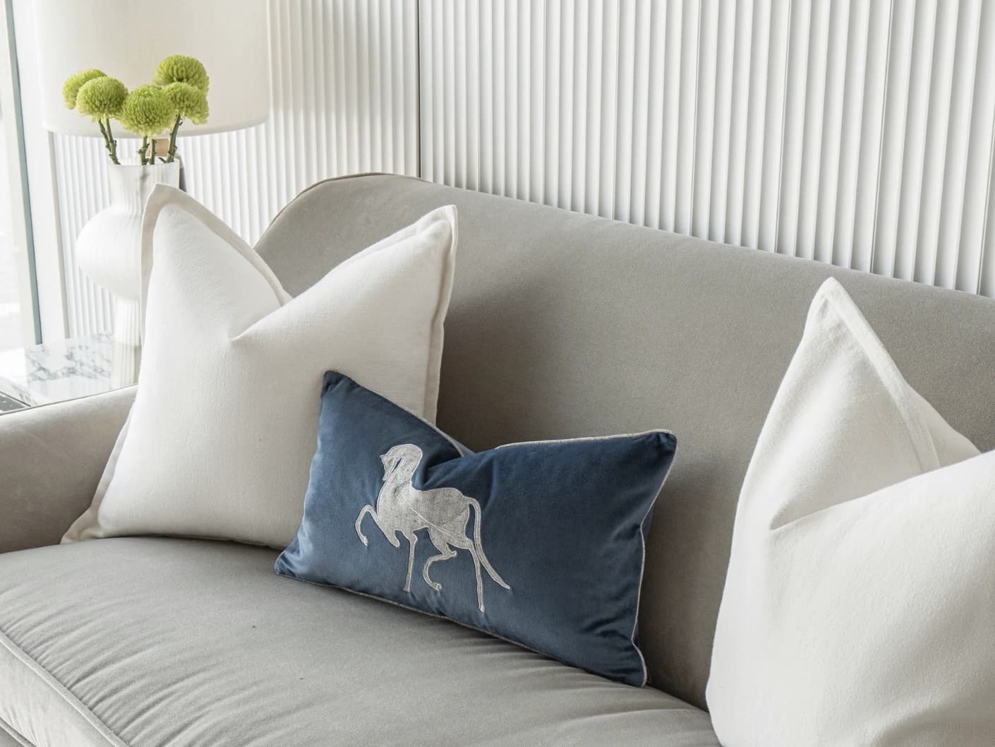 Brent Bundle bundle cushions in white, blue and silver, shown in a lifestyle front view