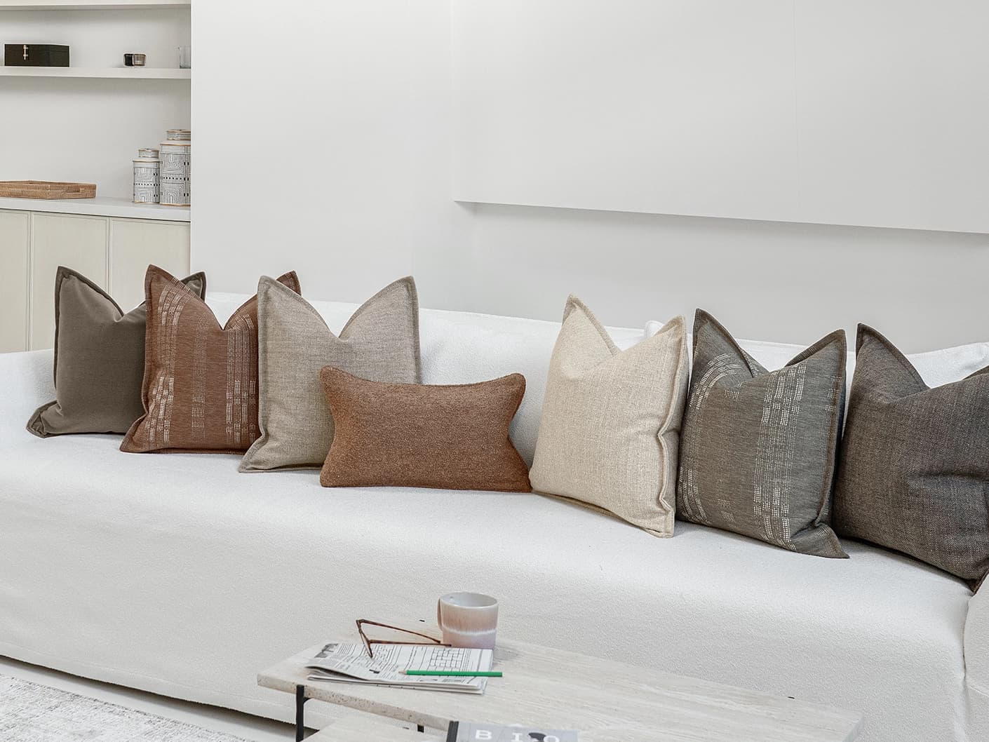 Bretty Bundle bundle cushions in brown, charcoal, taupe and beige, shown in a lifestyle front view