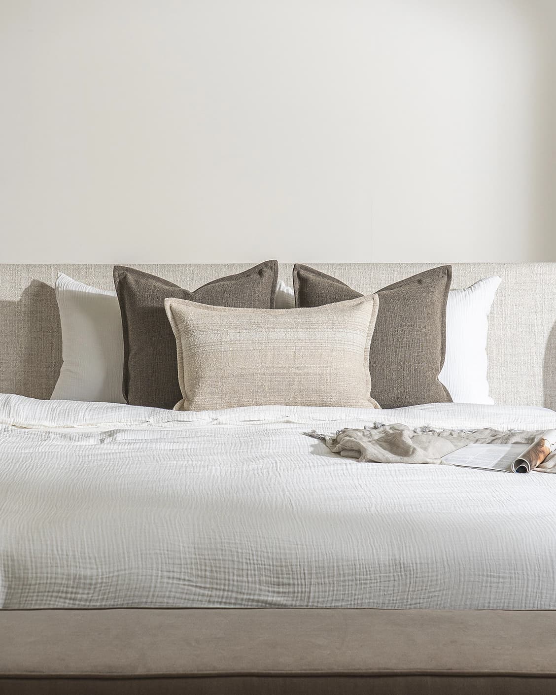Burhan Bundle cushion in brown and beige, shown in a lifestyle front view as image 2