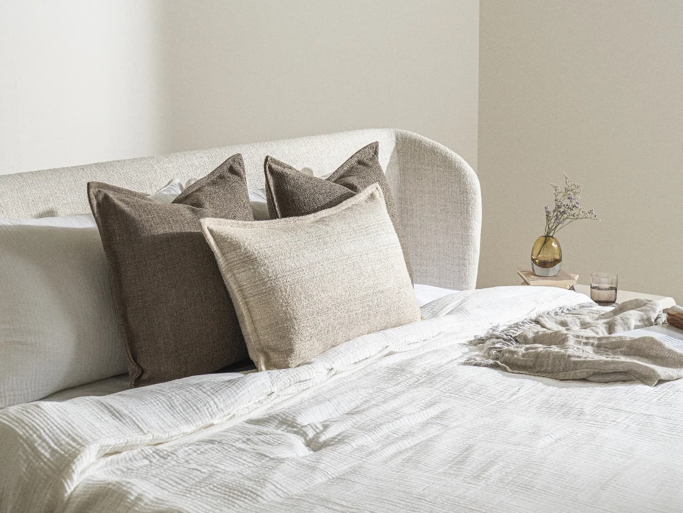 Burhan Bundle bundle cushions in brown and beige, shown in a lifestyle left view