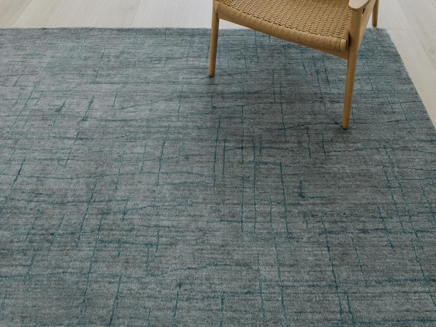 Caleb Ashton Round carpet in grey, teal and blue, shown in a lifestyle close-up top view as image 4