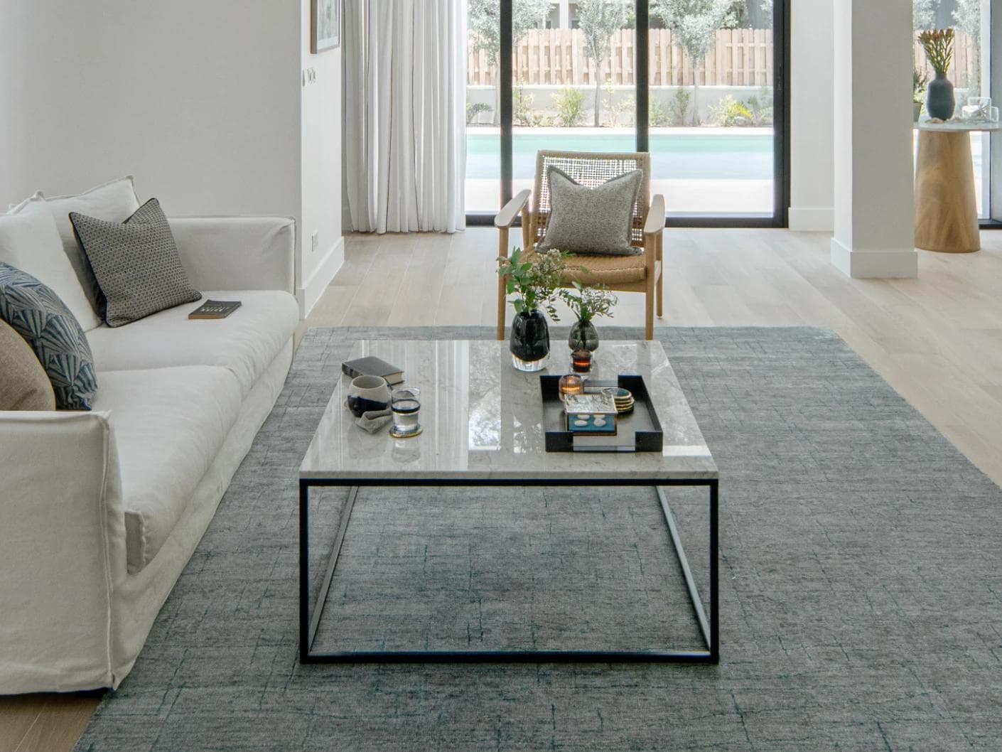 Caleb Ashton Round carpet in grey, teal and blue, shown in a lifestyle front view as image 5