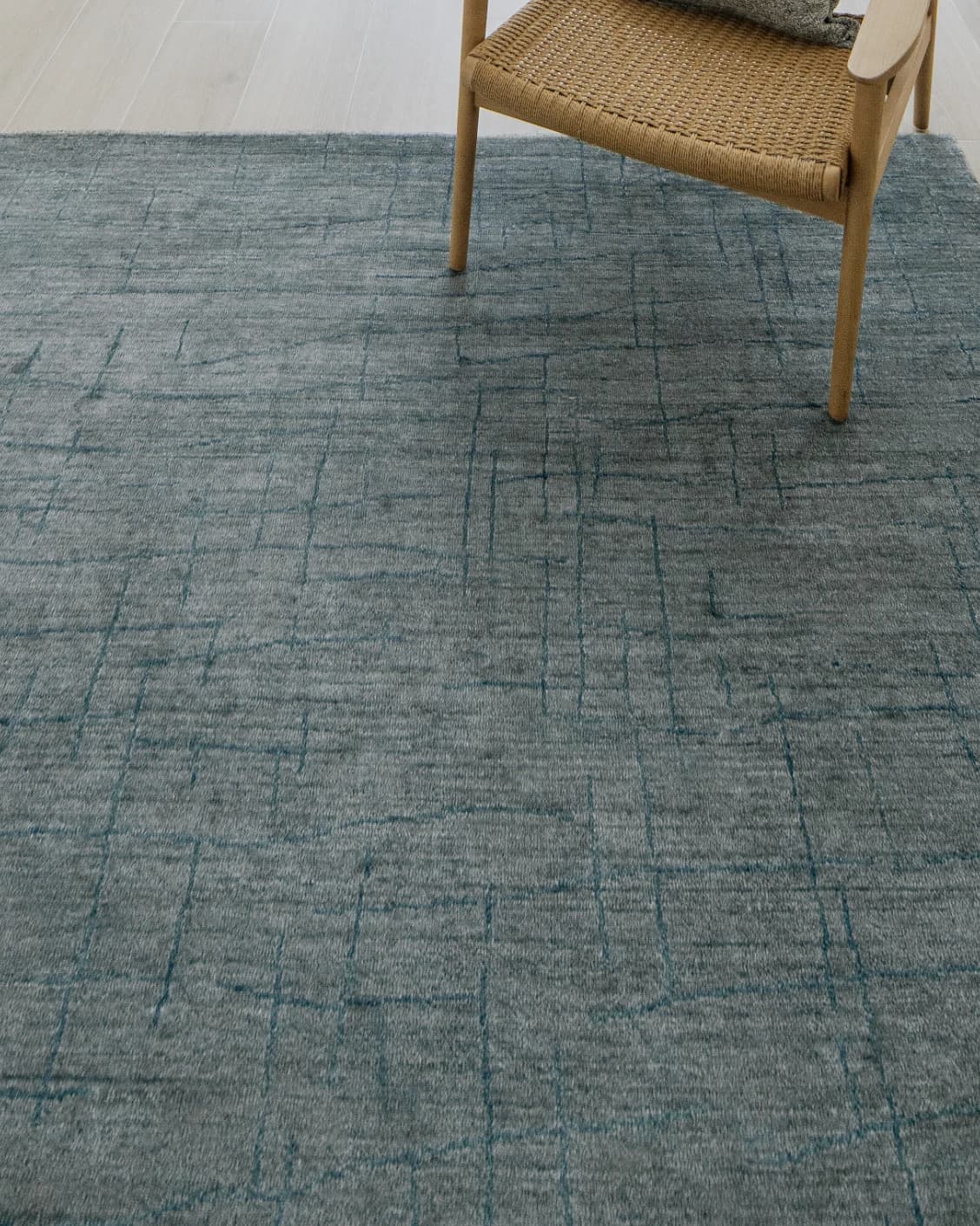 Caleb Ashton Round carpet in grey, teal and blue, shown in a lifestyle close-up top view as image 4