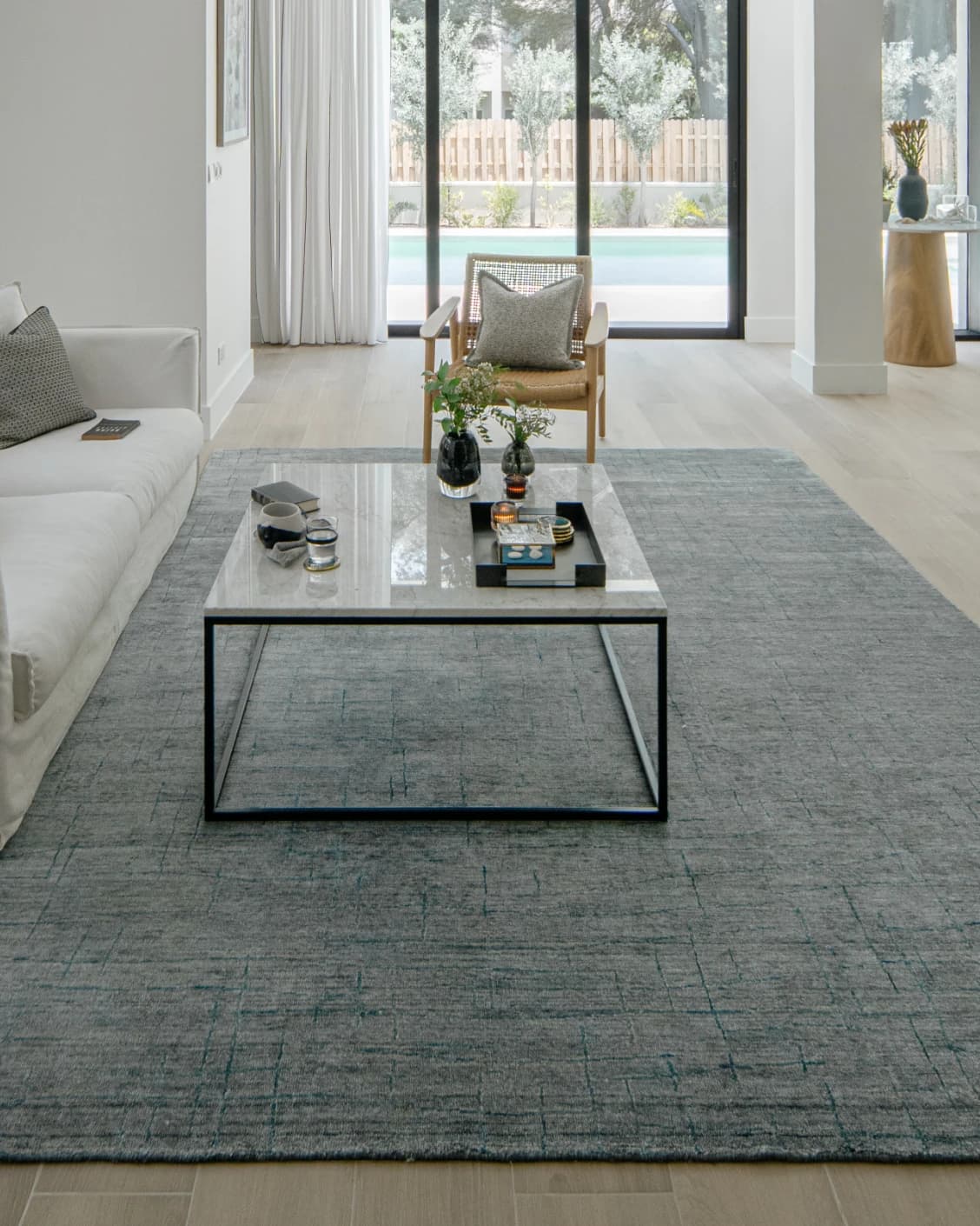 Caleb Ashton Round carpet in grey, teal and blue, shown in a lifestyle front view as image 5