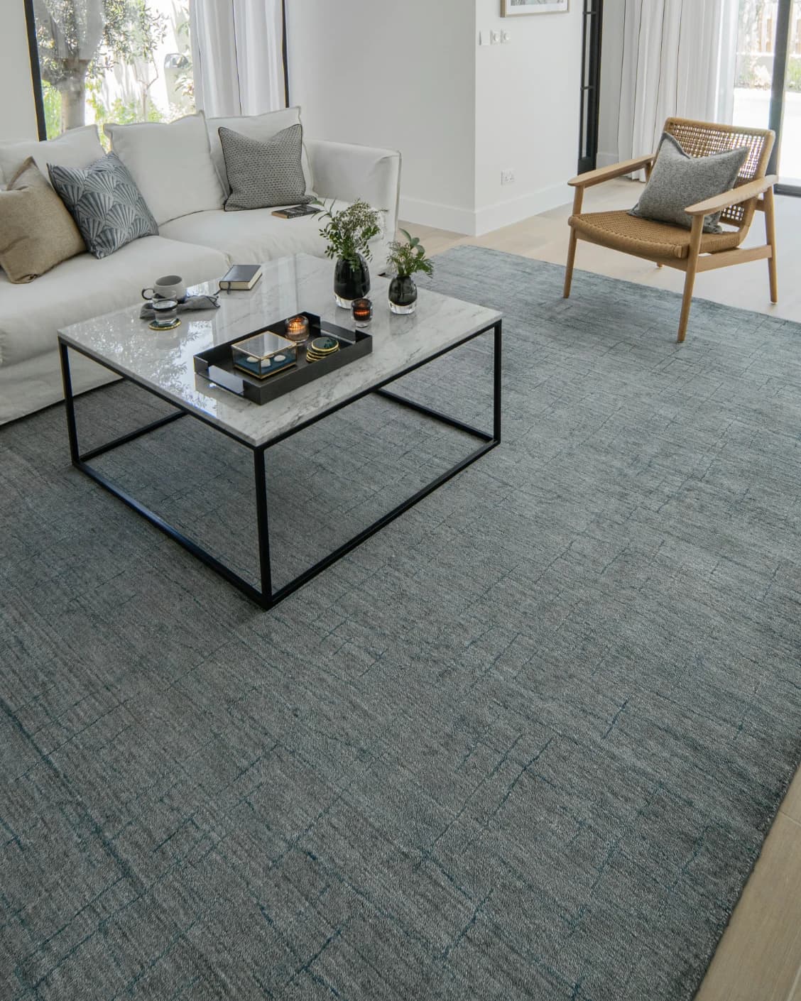 Caleb Ashton Round carpet in grey, teal and blue, shown in a lifestyle left view as image 9