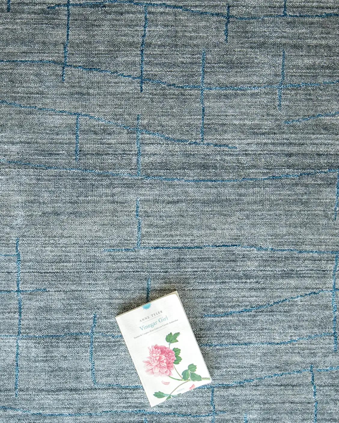 Caleb Ashton Round carpet in grey, teal and blue, shown in a lifestyle top view as image 12