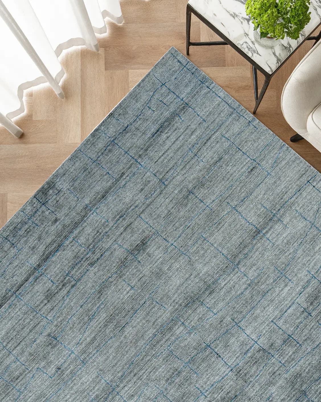 Caleb Ashton Round carpet in grey, teal and blue, shown in a lifestyle top view as image 11