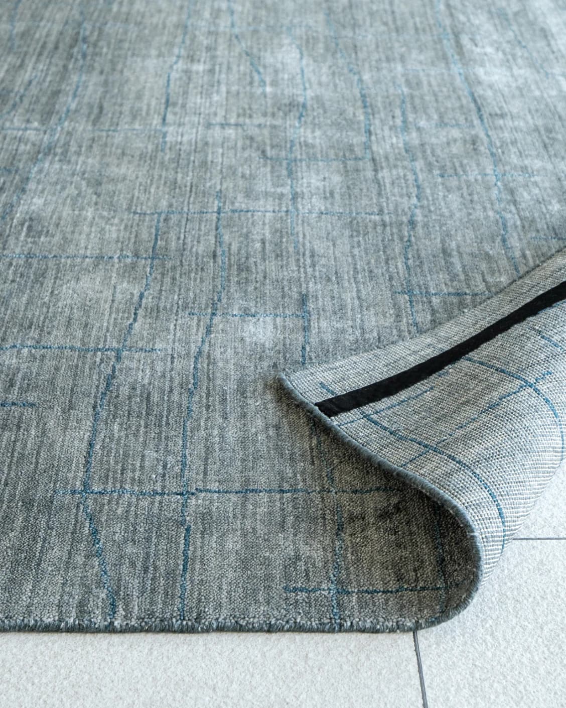 Caleb Ashton Round carpet in grey, teal and blue, shown in a product close-up as image 15