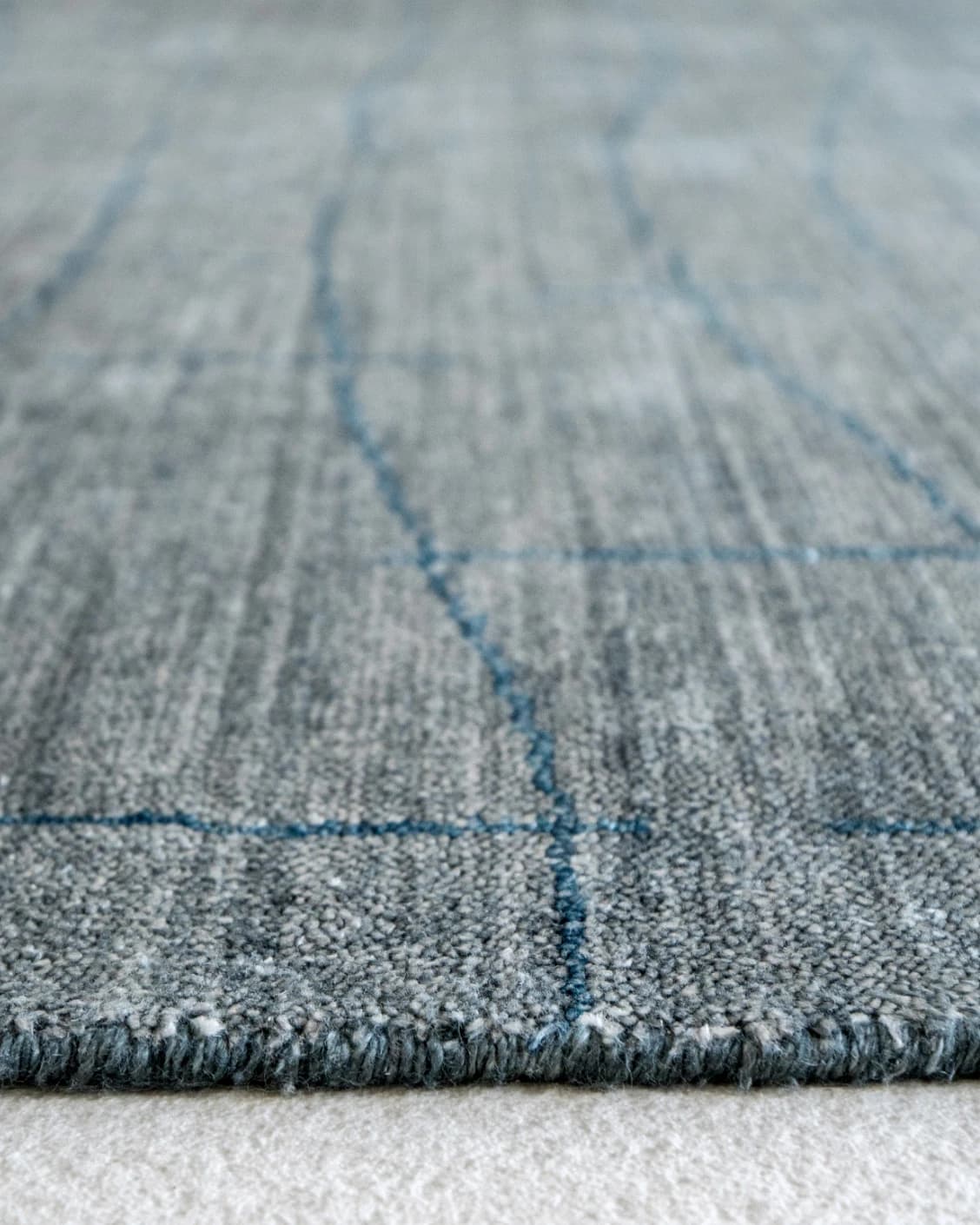 Caleb Ashton Round carpet in grey, teal and blue, shown in a product close-up front view as image 13