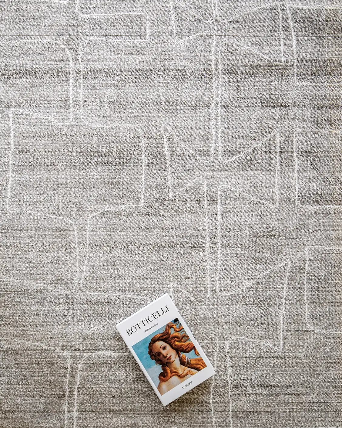 Caleb Dune carpet in grey and blue, shown in a lifestyle top view as image 7
